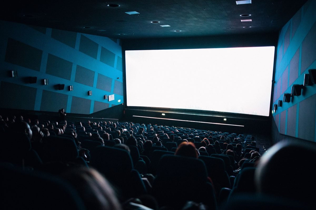 Crowded movie theater audience watching a screening, illustrative photo