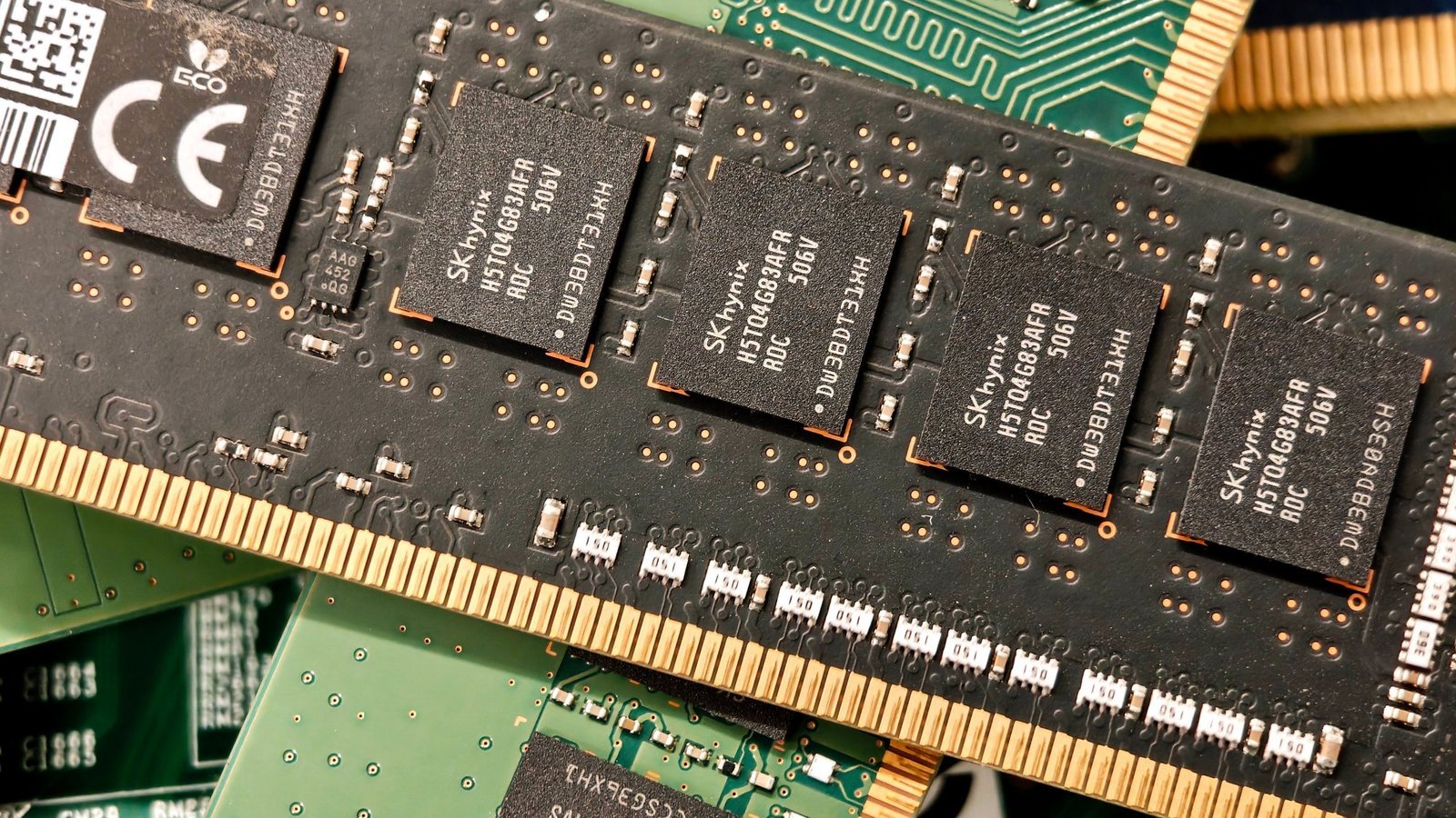 Close-up of DRAM memory modules with black chips on green circuit boards, illustrative photo for the RAM shortage and console prices